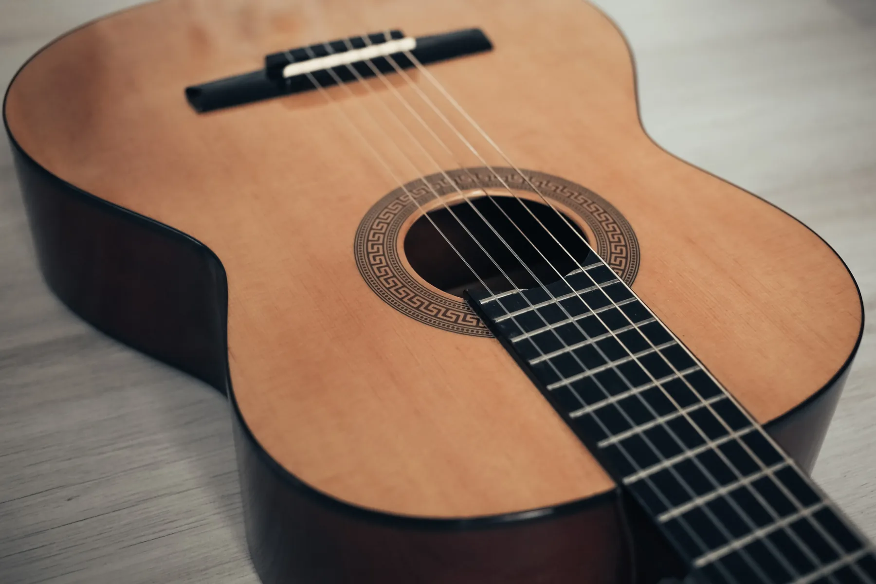Close-up of the strings and body of a classical guitar.